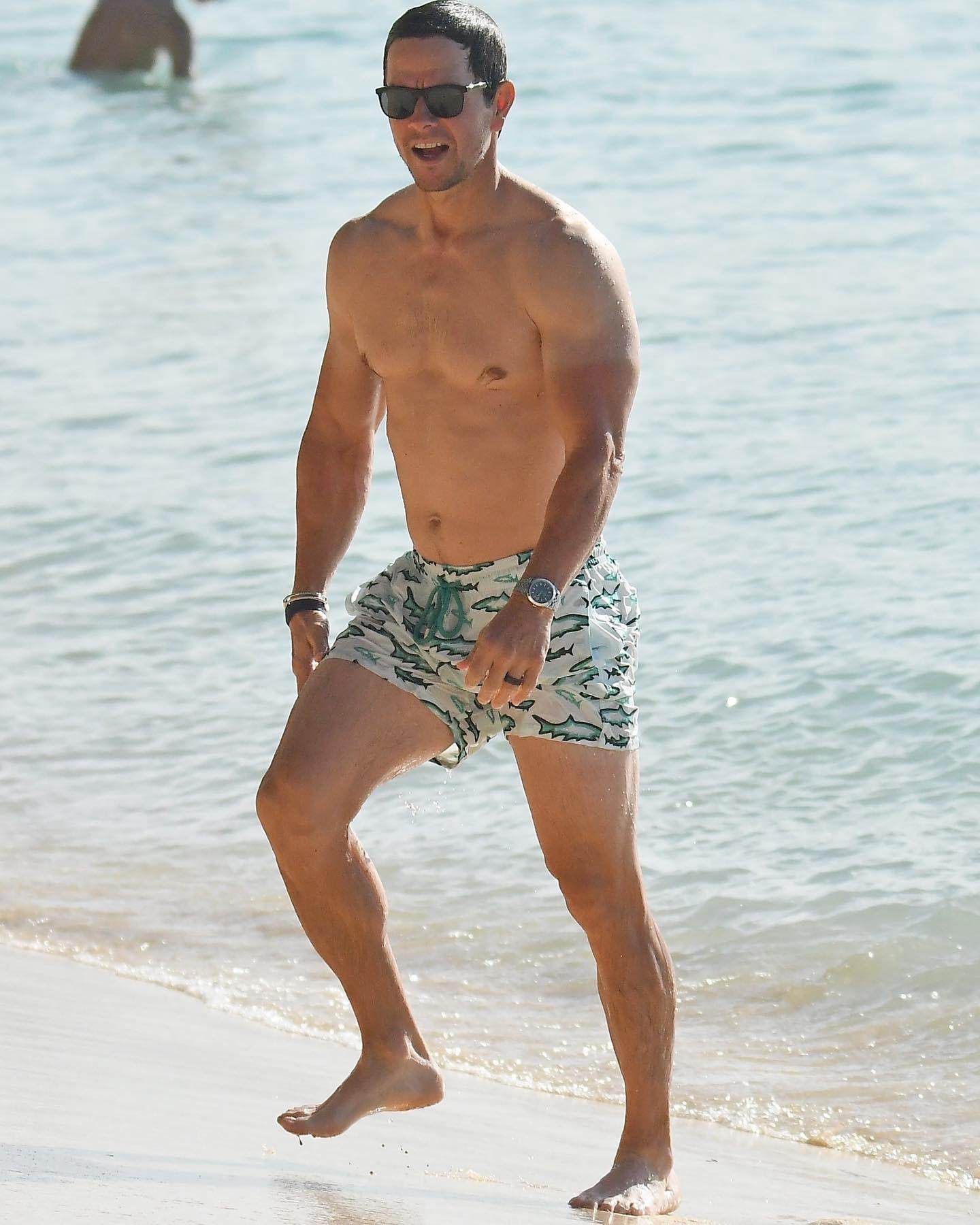 Just Jared - Mark Wahlberg sports a pair of shark-print swim trunks during another day at the beach