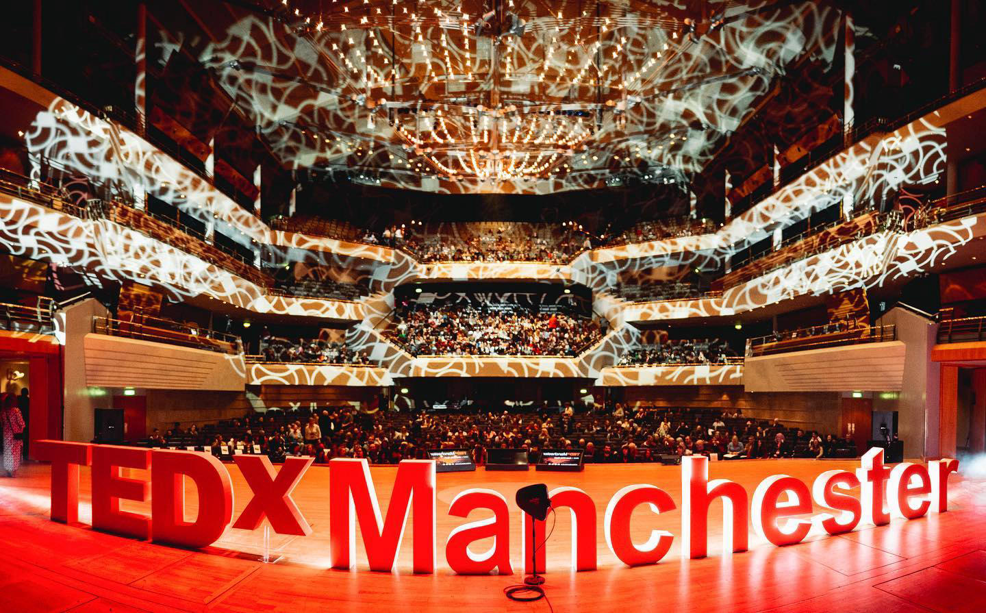 Kaleidoscopic lighting casts a surreal web over the TEDxManchester theater in Manchester, United Kin